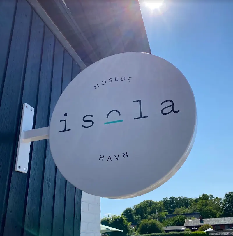 isolas runde skilt med teksten Mosede Havn på facaden, mod en blå himmel.